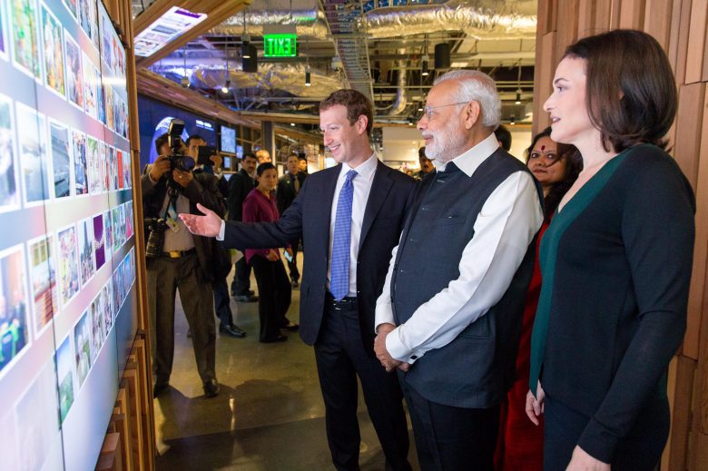 Mark Zuckerberg looking at a wall, together with Indias prime minister Modi.