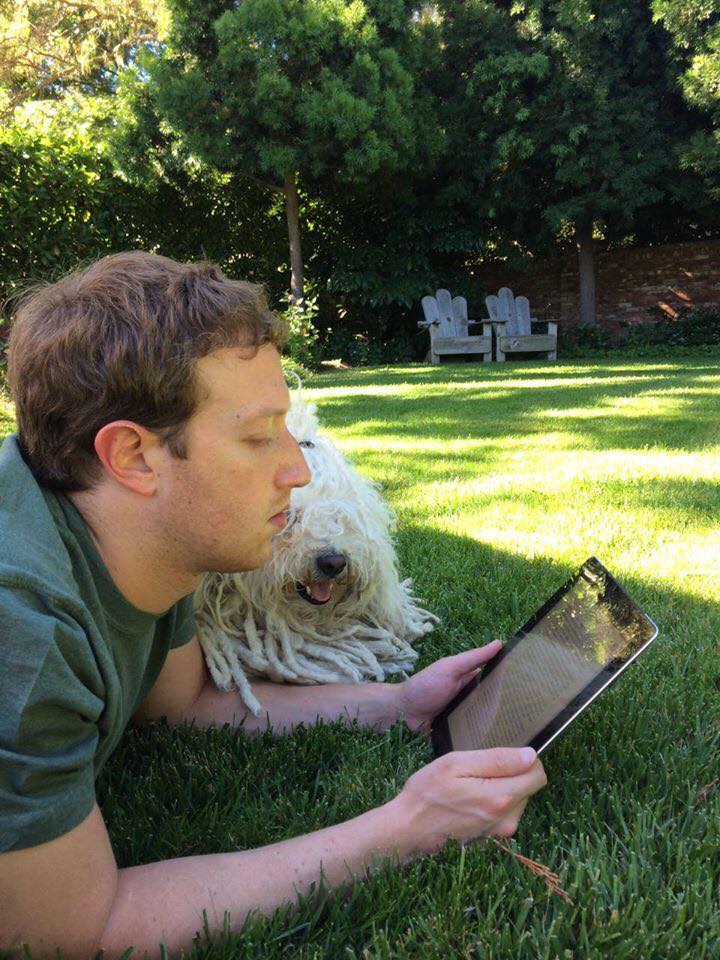 Mark Zuckerberg looking at an iPad.